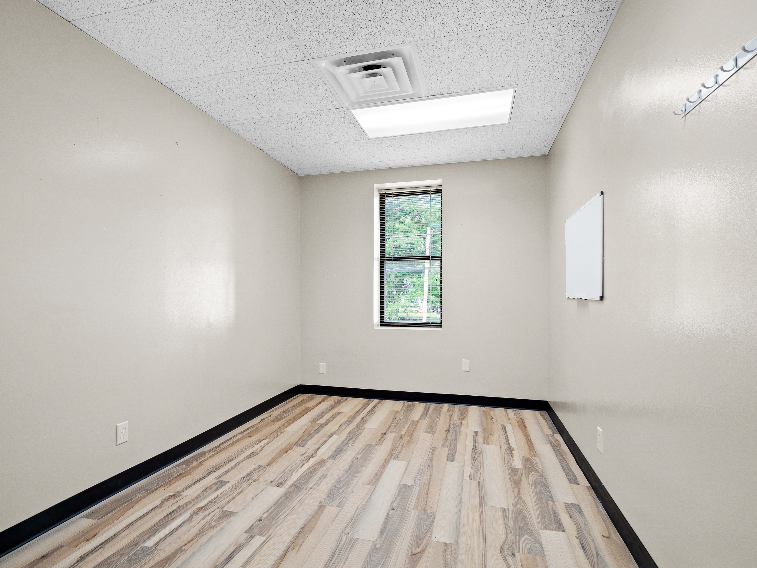 Small office with wood floors and natural light